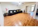 Comfortable living room with wood floors and a plush black reclining sofa at 2115 W Myrtle Ave, Phoenix, AZ 85021