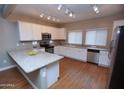 Well-lit kitchen features modern appliances, granite countertops, and ample cabinet space at 2150 W Alameda Rd # 1109, Phoenix, AZ 85085
