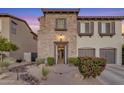 Charming two-story home with stone accents and desert landscaping in the front yard at 22317 N 39Th Run, Phoenix, AZ 85050