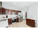Well-lit kitchen with stainless steel appliances, dark wood cabinets and sleek countertops at 2402 E 5Th St # 1498, Tempe, AZ 85288