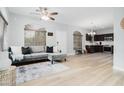 Open floor plan showcasing the living room, dining area, and kitchen with hardwood floors at 2402 E 5Th St # 1498, Tempe, AZ 85288