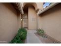 Welcoming front entrance adorned with lush greenery, offering a charming approach to the home at 2434 S Colleen Sw --, Mesa, AZ 85210
