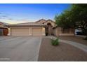 Inviting front exterior of a home showcasing a three-car garage and a meticulously landscaped yard at 2434 S Colleen Sw --, Mesa, AZ 85210