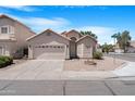 Inviting single-story home featuring low maintenance landscaping, a two-car garage and a tile roof at 254 W Amoroso Dr, Gilbert, AZ 85233