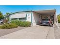 Single-story home with covered parking; tidy landscaping with flowers and gravel at 2650 W Union Hills Dr # 164, Phoenix, AZ 85027