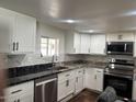 Bright kitchen with white cabinetry, stainless steel dishwasher, and stylish countertops at 2721 E Beverly Ln, Phoenix, AZ 85032