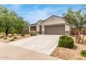 Beautiful single-story home with desert landscaping, a two-car garage, and inviting curb appeal at 30390 W Mitchell Ave, Buckeye, AZ 85396