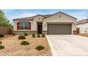 Charming single-story home with a well-maintained desert landscape and a two-car garage at 30390 W Mitchell Ave, Buckeye, AZ 85396