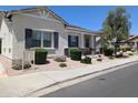 Charming single-story home with a landscaped front yard and desert landscaping along the sidewalk at 324 N 56Th Pl, Mesa, AZ 85205