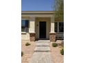 Inviting home entrance with a stone paver walkway and a covered front porch with decorative columns at 324 N 56Th Pl, Mesa, AZ 85205