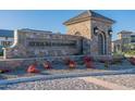 Elegant stone sign marks the entrance to Atrium at Somerset with manicured landscaping and stone guard house at 3332 S Quinn Ave, Gilbert, AZ 85297