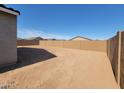 An expansive, enclosed backyard providing privacy and ample space for various outdoor activities at 335 S San Gregorio Ln, Casa Grande, AZ 85194