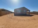 Spacious backyard with a covered patio, perfect for outdoor entertaining and relaxation at 335 S San Gregorio Ln, Casa Grande, AZ 85194