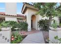 Charming home exterior featuring an arched entrance, lush landscaping, and a well-manicured walkway at 3417 E Mission E Ln, Phoenix, AZ 85028