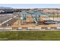 Fun playground with slides and seating in a community park, perfect for outdoor Gathering activities at 37357 W San Sisto Ave, Maricopa, AZ 85138