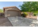 Well-maintained single-story home with desert landscaping, and a two-car garage at 43121 W Sunland Dr, Maricopa, AZ 85138