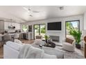 Bright and airy living room with a fireplace, modern furniture, and seamless flow to the kitchen at 5909 E Crocus Dr, Scottsdale, AZ 85254
