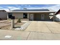 Charming single-story home with solar panels, low maintenance desert landscaping and covered parking at 5924 W Tierra Buena Ln, Glendale, AZ 85306
