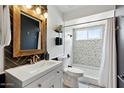 Stylish bathroom featuring modern fixtures, herringbone tile accent wall, and shower with mosaic tile at 605 W Sandra Ter, Phoenix, AZ 85023