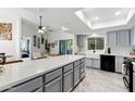 Bright kitchen with a large center island, gray cabinets, modern appliances, and stylish tile flooring at 605 W Sandra Ter, Phoenix, AZ 85023