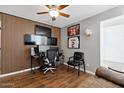Modern office space with wood accent wall, ample monitors, sporty decor, and comfortable seating at 605 W Sandra Ter, Phoenix, AZ 85023