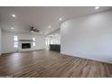 Spacious living room with a fireplace, fan, and wood-look floors at 619 N Norfolk --, Mesa, AZ 85205