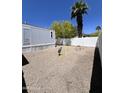 Gravel backyard featuring a white picket fence at 625 W Mckellips Rd # 111, Mesa, AZ 85201