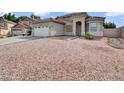 Desert-style front yard and a spacious two-car garage give great curb appeal to this home at 6752 W Citrus Way, Glendale, AZ 85303