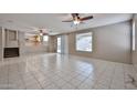 Spacious living room with tile flooring and a sliding door leading to the backyard at 6833 W Tether Trl, Peoria, AZ 85383