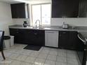 Well-lit kitchen with black cabinets, gray countertops, and stainless-steel appliances, offering style and functionality at 740 N Oracle --, Mesa, AZ 85203