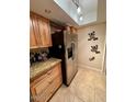 Spacious kitchen featuring granite countertops, stainless steel refrigerator, and wood cabinets at 7432 E Hum Rd # 203, Carefree, AZ 85377