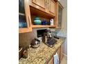 Close-up of kitchen showcasing granite countertops and updated wood cabinets at 7432 E Hum Rd # 203, Carefree, AZ 85377