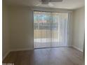 Cozy bedroom with laminate flooring, bright window, and access to a private balcony at 7575 E Indian Bend Rd # 1100, Scottsdale, AZ 85250