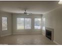 Bright living room with a ceiling fan, fireplace, and plenty of natural light at 7575 E Indian Bend Rd # 1100, Scottsdale, AZ 85250