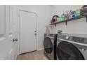 Well-equipped laundry room with modern Samsung washer and dryer, storage shelves, and access door at 7818 S 74Th Ave, Laveen, AZ 85339