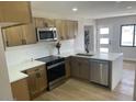 Well-lit kitchen with stainless steel appliances, updated cabinetry, and sleek countertops at 954 E Henry St, Tempe, AZ 85288