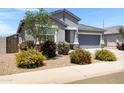 Inviting single-story home featuring a two-car garage and colorful desert landscaping at 1090 E Horro Rd, Queen Creek, AZ 85143