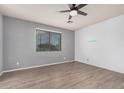 This spacious bedroom features wood plank flooring, a ceiling fan, neutral paint, and a large window at 1265 S Aaron -- # 341, Mesa, AZ 85209