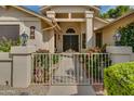 Inviting gated front entrance with desert landscaping and decorative lighting fixtures at 13731 W Greenview Dr, Sun City West, AZ 85375