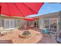 A beautiful covered patio with a fire pit and outdoor furniture providing a comfortable and inviting space at 13806 N Del Webb Blvd, Sun City, AZ 85351