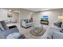 Inviting living room with stylish seating, a glass coffee table, and wood-look flooring at 13806 N Del Webb Blvd, Sun City, AZ 85351