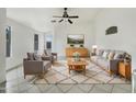 Bright living room featuring a modern ceiling fan and neutral-colored furnishings at 1399 E Santa Fiore St, San Tan Valley, AZ 85140