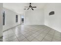 Open concept living room featuring tile flooring and a ceiling fan at 1399 E Santa Fiore St, San Tan Valley, AZ 85140