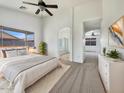 Bright main bedroom features a ceiling fan, a neutral color palette, and ensuite bathroom entrance at 1399 E Santa Fiore St, San Tan Valley, AZ 85140