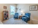 Cozy living area with matching recliner chairs, soft carpet, and natural light from large window at 14080 N Newcastle Dr, Sun City, AZ 85351