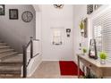 Inviting foyer with stairs, natural light, decorative table, and neutral color palette at 1446 E Douglas St, Casa Grande, AZ 85122