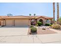 Charming single-story home featuring a tile roof, stone accents, desert landscaping, and a spacious three-car garage at 1625 W Gunstock Loop, Chandler, AZ 85286