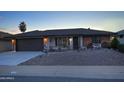 Charming single-story brick home featuring a low-maintenance desert landscape and an attached two-car garage at 228 N 65Th Pl, Mesa, AZ 85205