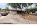 Lovely home with a well-kept front yard, a long driveway, and an attached two-car garage at 2320 W El Alba Way, Chandler, AZ 85224