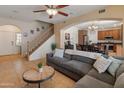Spacious living room with tile flooring, ceiling fan, and an open view of the staircase at 2331 E Sunland Ave, Phoenix, AZ 85040